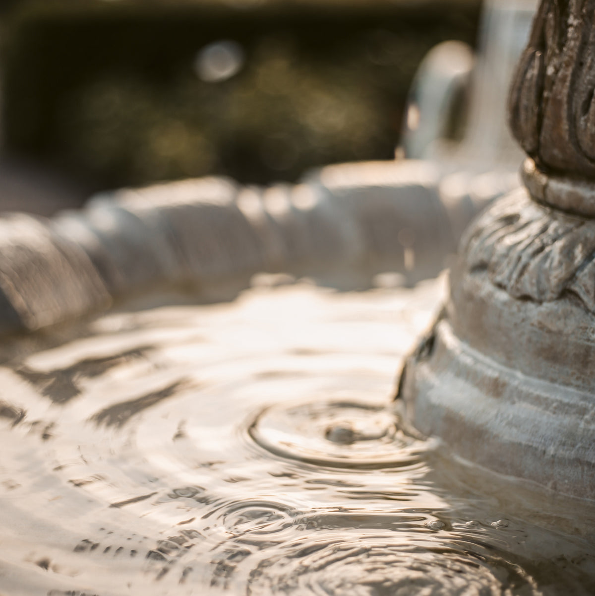 closeup of a decorative fountain with ripples in the water