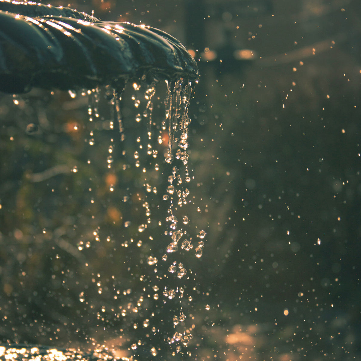closeup of a decorative fountain with water flowing off the edge