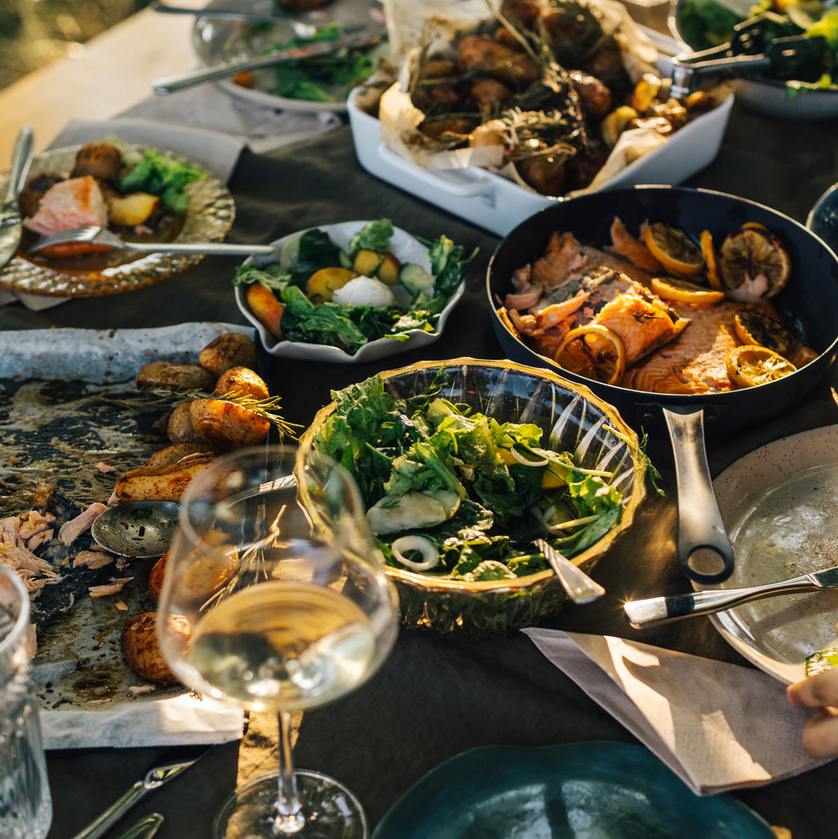 a table with multiple dishes of grilled foods