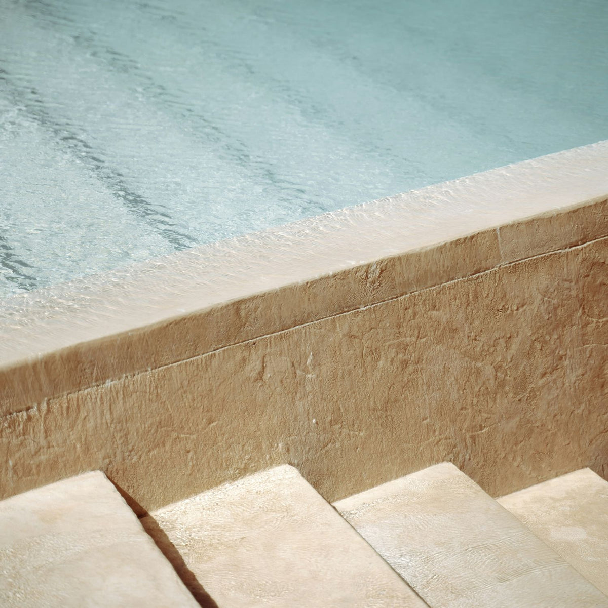 a closeup of stair steps alongside a pool