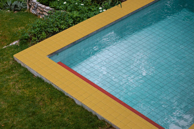 From Aqua to Navy: 10 Blue Pool Waterline Tile Ideas